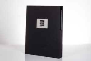 Black folder with silver logo on front.