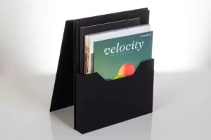 Black magazine holder with books and magazine.