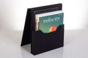 Black magazine holder with magazines inside.