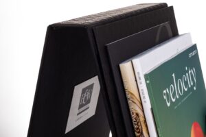 Magazine holder with assorted books and magazines.