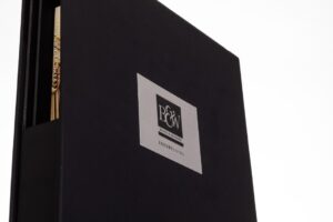 Black book with P&W logo, pen inside.