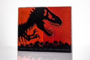 Red dinosaur silhouette on DVD box cover.
