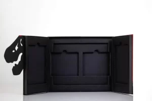 Black dinosaur-themed book packaging, open view.