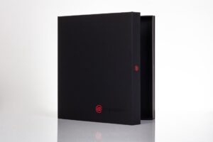 Black box with red logo, partially open.