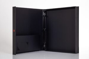 Black open binder with pockets and rings.