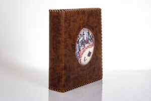 Brown leather album with baseball-themed cover.