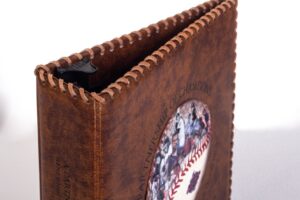 Leather-bound photo album with baseball design.
