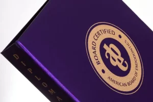 Purple diploma cover with certification seal.