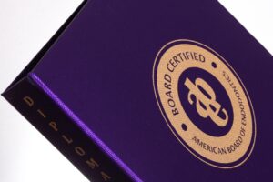 Purple diploma folder with certification seal.