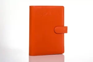Orange leather notebook with clasp closure.