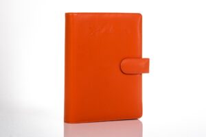 Orange leather binder with button closure.