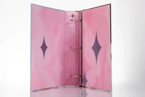 Pink binder with star patterns inside.
