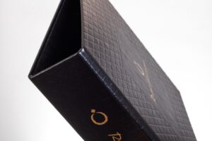 Black textured binder with gold lettering.