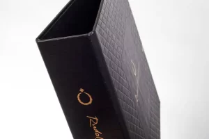 Black textured box with gold lettering.