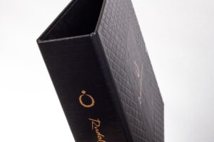 Black textured binder with gold lettering.