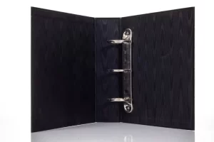 Open black binder with metal rings.