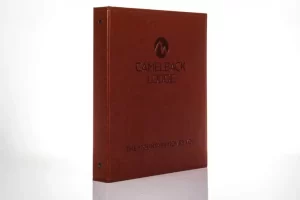 Brown Camelback Lodge binder against white background.