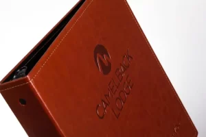 Brown binder labeled "Camelback Lodge" on cover.