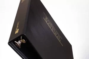 Black binder with gold text on cover.