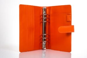 Orange leather binder with metal rings.