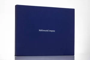 Blue McKinsey & Company box on table.