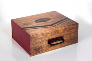 Wooden box with handle and red side.