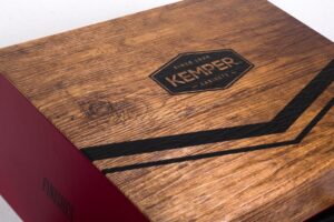 Wooden box with Kemper logo design.