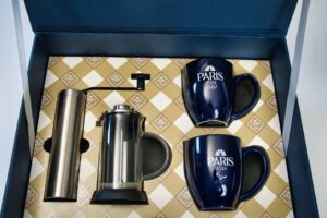 Paris 2024 mugs and coffee set display.