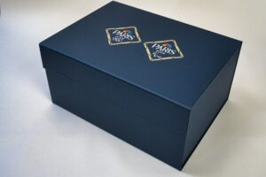 Dark blue box with Paris logos.