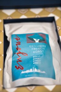 Coffee bag labeled "Exquisite French Roast" in box.