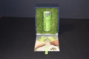 Green energy drink can in decorative box.