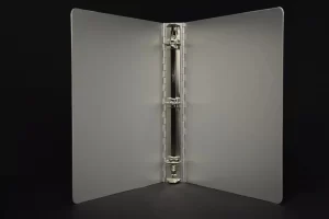Open three-ring binder against black background. Open three-ring binder against black background.