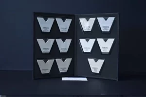 Metallic plaques displayed in an open folder.