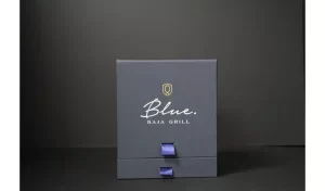 Blue Baja Grill gift box on black background.