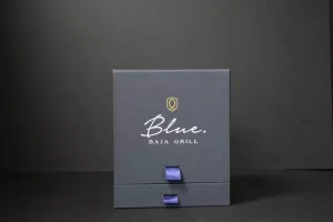 Blue Baja Grill box with ribbon accents.