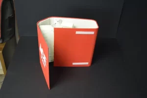 Red accordion file folder on black background.