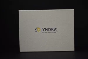 Solyndra logo on a textured box.