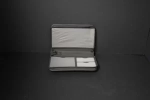 Open gray fabric case against dark background.