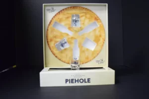 Pie-themed packaging with liquor bottles inside.