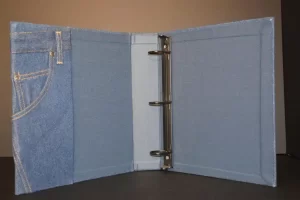 Denim-designed binder with metal rings.
