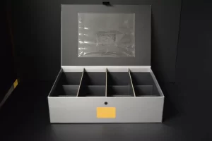 Gray storage box with multiple compartments open.