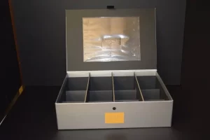 Open gray storage box with compartments.