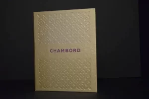 Gold book with "CHAMBORD" embossed cover.