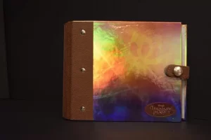 Colorful album with brown leather binding.