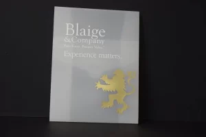 Plaque with company name and lion emblem.