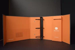 Orange open binder with three-ring mechanism.