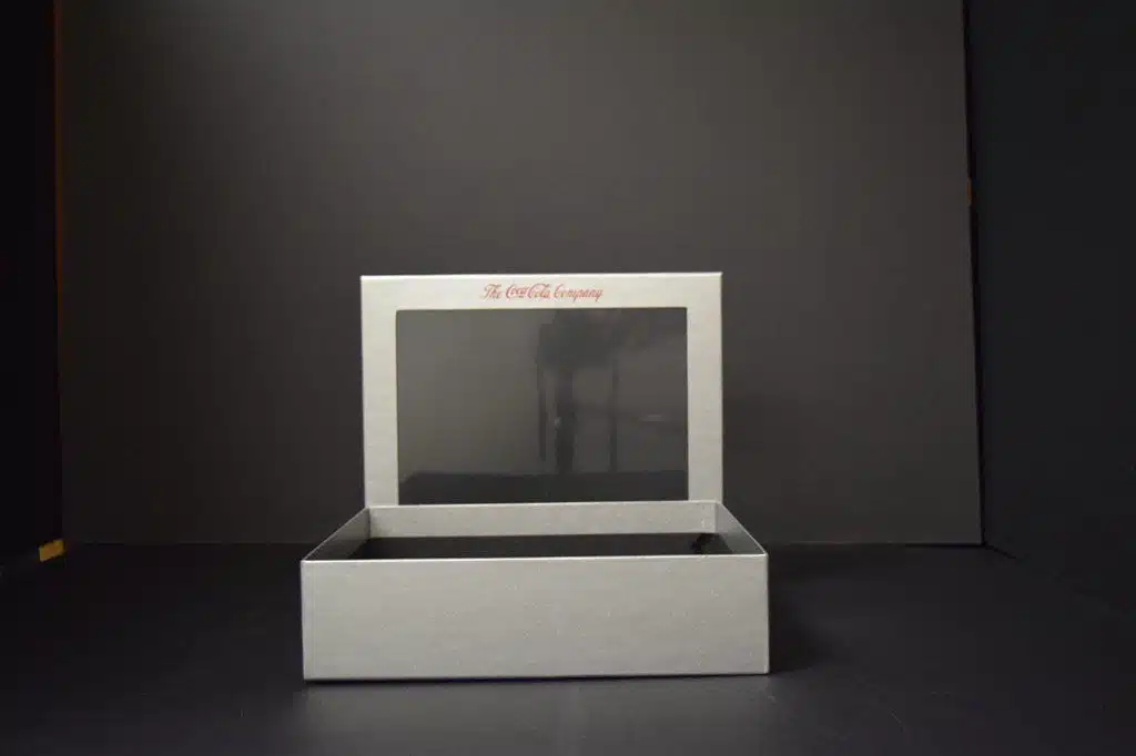 Open gray box with transparent lid.