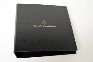 Black binder with textured design and logo.