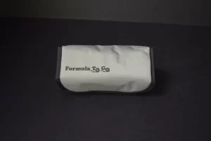 White "Formula To Go" pouch on table.