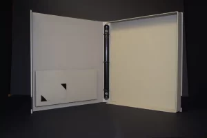 Open empty binder on dark background.